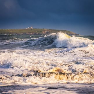 stormy seas from the long strand with the Galley Head in the distance.
