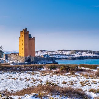 An image of Kilcoe Castle covered in snow, a great Christmas gift idea.